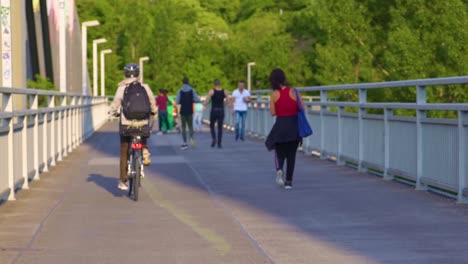 Still-slow-motion-shot,-people-walking-on-Vienna-bridge-on-sunny-day,-nature-background