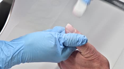 Closeup-shot-of-a-woman-in-a-nail-salon-receiving-a-manicure-by-a-beautician-with-a-nail-file