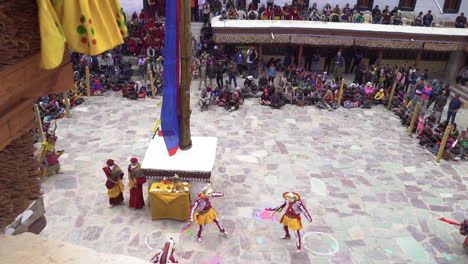 Monks-dancing-wearing-colorful-masks-at-Hemis-Monastery-on-Hemis-festival,-moving-camera-shot