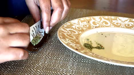 African-American-woman's-hands-rolling-marijuana-cannabis-into-a-cigar