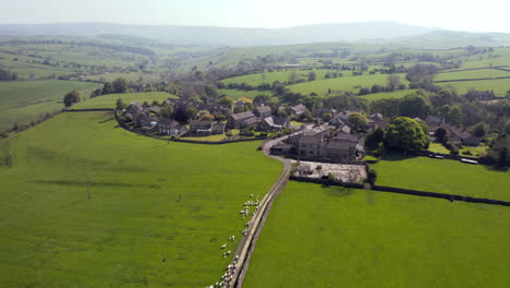 Aerial-Flyby-of-Sheep-being-Herded-into-Small-Yorkshire-Village-on-Sunny-Summer’s-Day-in-England