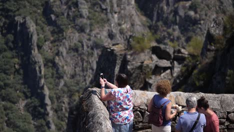 Tourist-taking-photo-the-Ribeira-Sacra-in-Spain,-still-pan-up