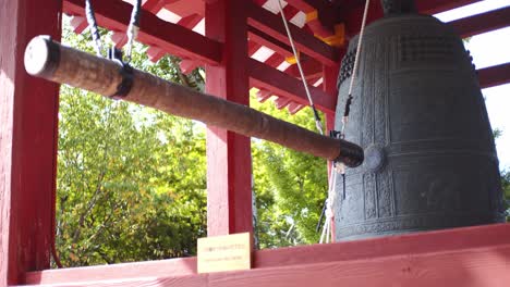Traditional-asian-bell-hanging-outside-a-temple-in-Kyoto,-Japan-close-up-4K