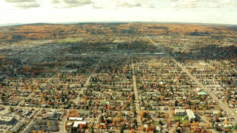 A-cinematic,-aerial-view-of-the-city-of-Prince-George-downtown-area,-focusing-entirely-on-the-expansive-residential-that-populate-the-core-of-the-city-during-the-autumn---fall-season