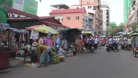 Wide-shot-showing-crowd-strolling-through-street-market-during-motorbikes-driving-in-street