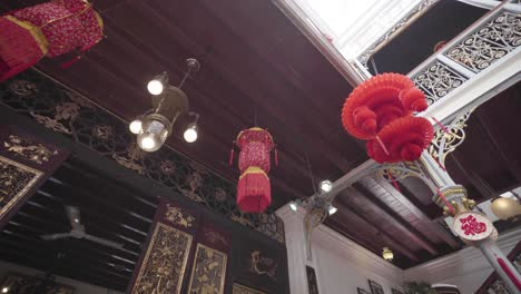 Chinese-Paper-Lantern-in-Asian-Courtyard,-Low-Angle-Tracking-Shot