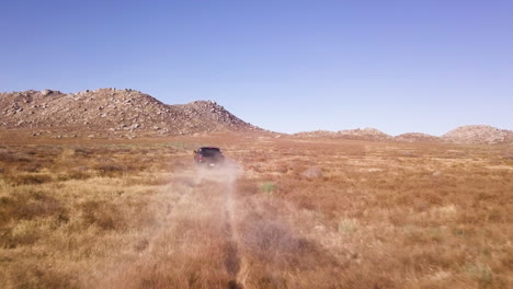 Unidentified-black-off-road-car-drives-through-the-desert