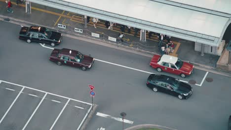 High-angle-view-of-taxis-picking-up-customers-at-train-station