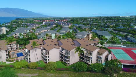 Flying-low-next-to-a-complex-of-residential-buildings-on-Kihei,-Hawaii-on-a-sunny-day,-truck-move-to-the-right