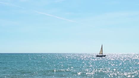 Segelboot-Bewegt-Sich-An-Einem-Sonnigen-Tag-Mit-Einem-Wunderschönen-Blauen-Himmel-Im-Hintergrund-Nach-Rechts