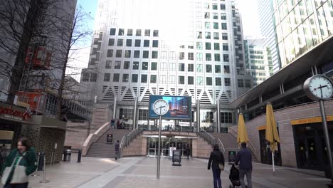 POV-walking-towards-a-clock-at-Reuters-Plaza-in-middle-of-sunny-day