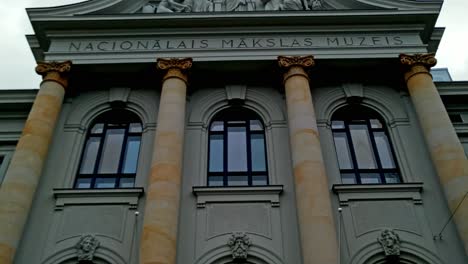 Entrance-of-Latvian-national-museum-of-art,-cloudy-day,-pan-down