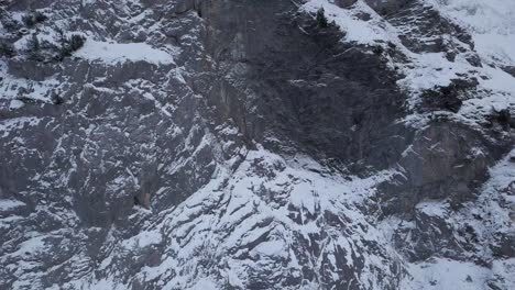 aerial-detail-of-a-alpine-mountain-wall-and-the-abandoned-cable-car-station-Wetterhorn-Aufzug-in-Grindelwald