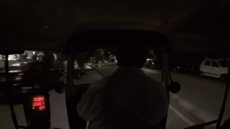 Rickshaw-driving-through-street-and-motorcycle-speeds-by