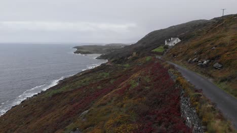 Aerial-of-roadway-next-to-irish-coastline-on-moody-day-with-bad-clouds