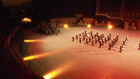 Drone-shot-of-hundreds-of-musicians-walking-out-of-the-tunnel-and-into-the-arena-in-Avenches-Switzerland