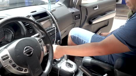 Mexican-Mechanic-Runs-The-Air-Conditioning-Of-The-Car-To-Verify-Gas-Levels-|-Slowmotion-Zoom-Out-Of-Technician-Adjusting-The-Air-Conditioner-Button-Controlers-in-Automotive-Repair-Shop