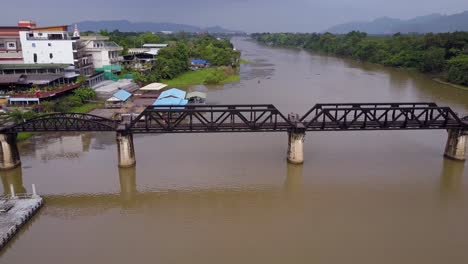 Aerial-Drone-shot-approaching-the-Bridge-Over-The-River-Kwai,-Thailand-Death-Railway,-Kanchanaburi,-Thailand