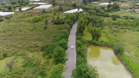 aerial-shot-of-a-moving-porsche-cayman-in-colombian-roads-during-a-sunny-bright-afternoon