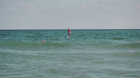 Girl-on-a-Paddle-Board-riding-in-the-sea