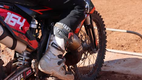 Rider-waiting-for-the-start-of-a-motocross-race,-is-boot-moving-anxiously-in-anticipation
