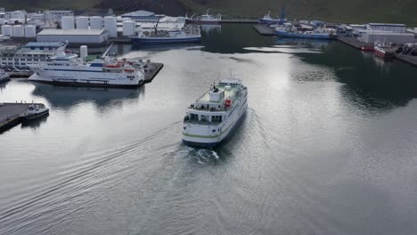 Aerial-shot-of-Vestmannaeyjar-harbor-on-Heimaey-island-with-ferry-arriving