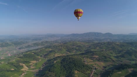 Lone-balloon-flies-over-wide-panoramic-landscape-on-sunny-day