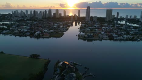 Drone-4K---Pull-back-reveal-of-Surfers-Paradise-skyline-at-dawn-with-dramatic-clouds