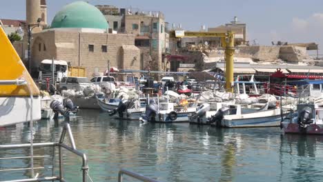 Boats-at-marina-of-Acre,-Israel-with-old-town-in-background