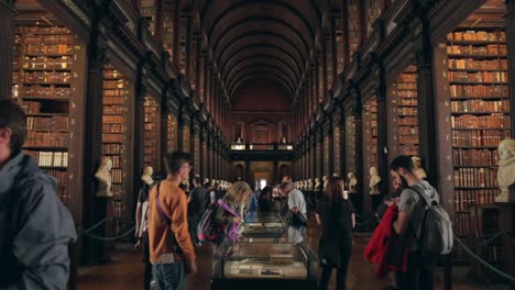 People-walking-around-in-the-Long-Room-in-Trinity-College-Library,-Dublin,-Ireland