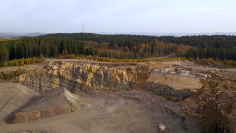 Aerial-view-of-quarry-in-forest-with-autumn-colours