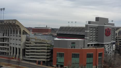 Ascend-aerial-shot-of-Jordan-Hare-Stadium-in-Auburn-during-cloudy-sky,-Auburn-Tigers-Football-University-Club