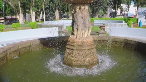 Slow-motion-shot-of-water-fountain-in-a-city-park