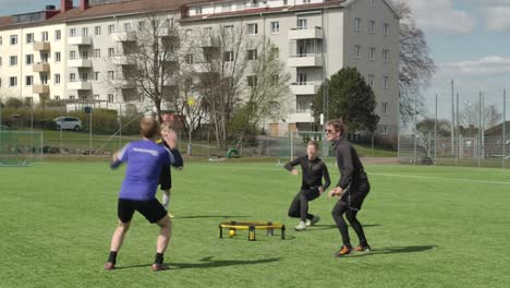 Roundnet-played-by-young-guys-at-sunny-day,-in-Sweden-Gothenburg