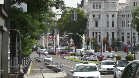 Slow-motion-shot-looking-down-road-towards-famous-Plaza-de-Cibeles,-Madrid
