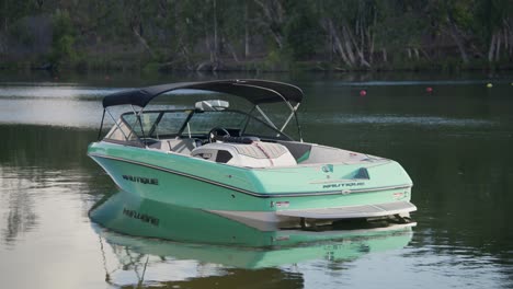 A-water-ski-boat-anchored-at-the-river-bank