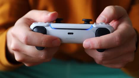 Close-up-of-hands-holding-and-playing-with-Playstation5-game-controller