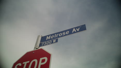 Melrose-Avenue-street-sign-on-top-of-a-stop-sign-durning-a-sunny-day