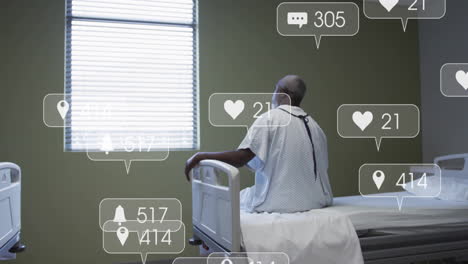 Animation-of-media-icons-over-african-american-male-patient-on-hospital-bed