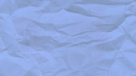 Animation-of-blue-creased-paper-over-shapes