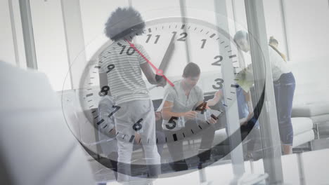 Animation-of-clock-moving-over-diverse-colleagues-discussing-work