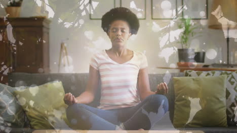 Animation-of-leaves-and-light-spots-over-african-american-woman-meditating,-slow-motion