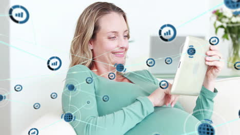 Animation-of-network-of-datacommunication-icons-over-happy-pregnant-caucasian-woman-using-tablet