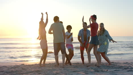 Eine-Bunt-Gemischte-Gruppe-Junger-Erwachsener-Genießt-Eine-Strandparty-Bei-Sonnenuntergang