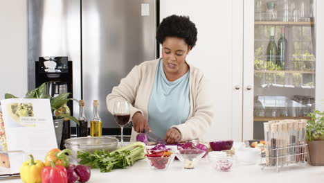 Play-back-cookery-show-of-an-African-American-woman-preparing-a-meal-in-a-modern-kitchen