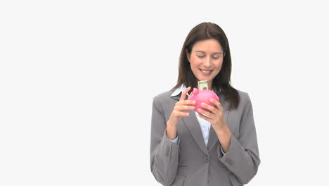 Happy-businesswoman-saving-money-in-a-piggybank-