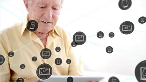 Animation-of-communication-network-over-happy-senior-caucasian-man-using-tablet