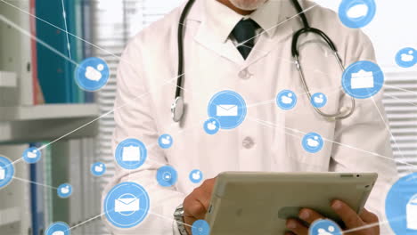 Animation-of-email-and-message-network-over-happy-caucasian-male-doctor-using-tablet