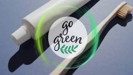 Animation-of-go-green-text-and-green-ring-over-toothpaste-tube-and-wooden-toothbrush