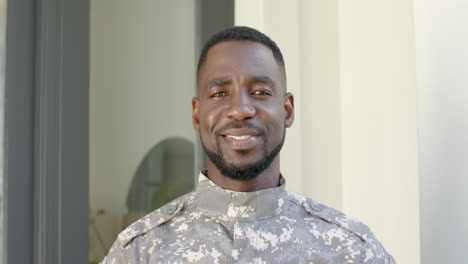 African-American-soldier-in-military-uniform-smiles-warmly-at-home